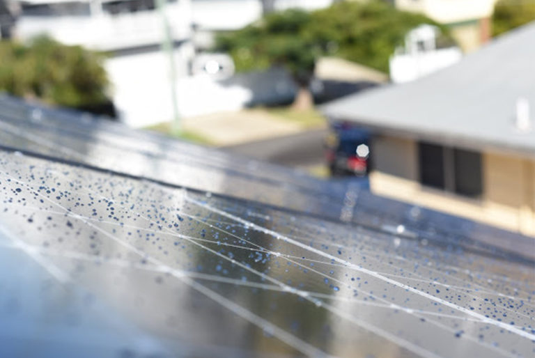 Rain and cloud covered solar panel - solar myths